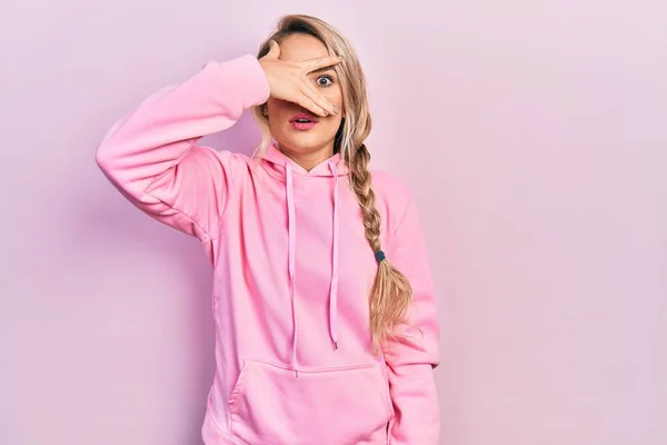 Beautiful Young Blonde Woman Wearing Pink Sweatshirt Peeking Shock Covering — Stockfoto