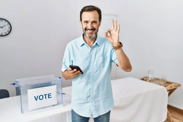 Middle Age Man Beard Political Election Using Smartphone Doing Sign — Stock fotografie