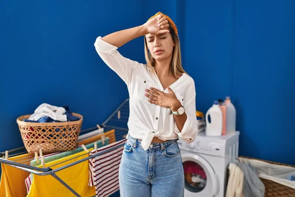Young Blonde Woman Laundry Room Touching Forehead Illness Fever Flu — Stockfoto