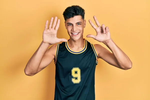 Young Hispanic Man Wearing Basketball Uniform Showing Pointing Fingers Number — 스톡 사진