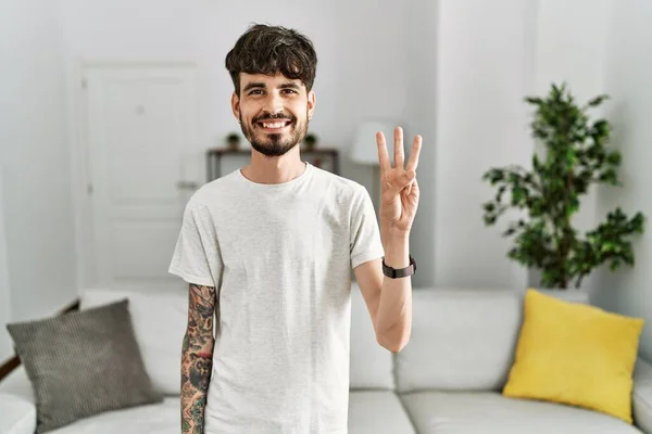 Hispanic Man Beard Living Room Home Showing Pointing Fingers Number — Stockfoto