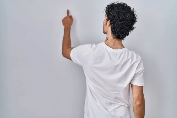 Hispanic Man Standing Isolated Background Posing Backwards Pointing Ahead Finger — Fotografia de Stock