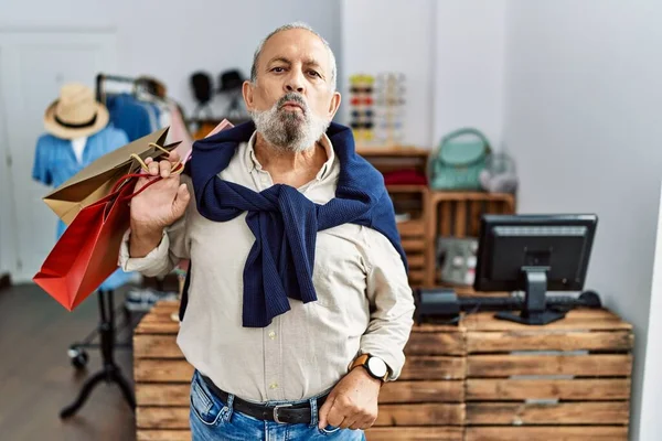 Handsome Senior Man Holding Shopping Bags Boutique Shop Looking Camera — Stockfoto