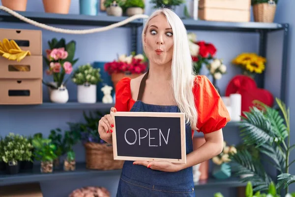 Caucasian Woman Working Florist Holding Open Sign Making Fish Face — Foto de Stock