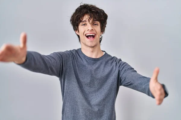 Young Man Standing Isolated Background Looking Camera Smiling Open Arms — Stok fotoğraf