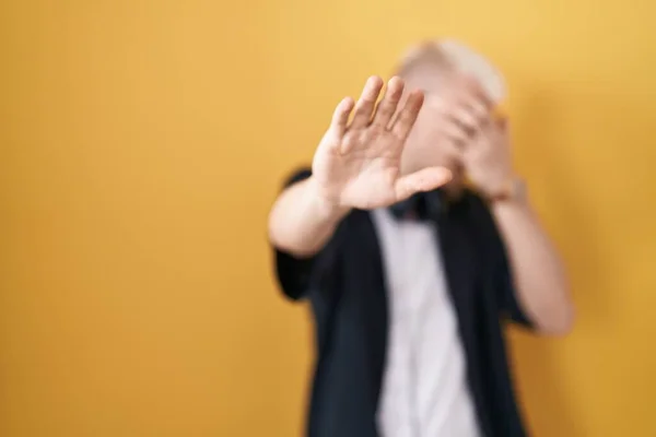 Young Caucasian Man Wearing Sunglasses Standing Yellow Background Covering Eyes — 图库照片