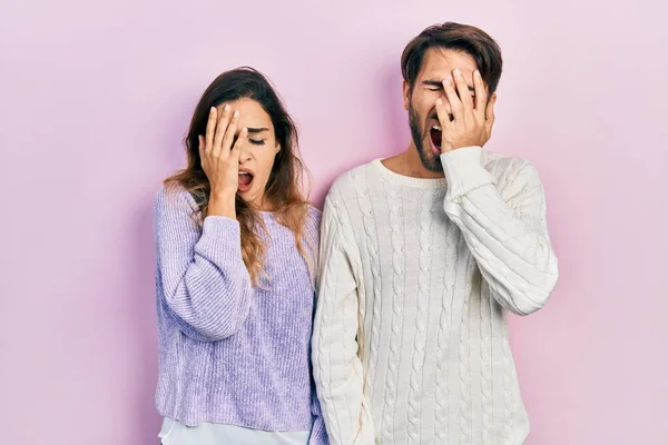 Young Hispanic Couple Wearing Casual Clothes Yawning Tired Covering Half — Stok fotoğraf