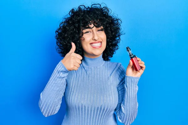 Young Middle East Woman Holding Electronic Cigarette Smiling Happy Positive — Fotografia de Stock