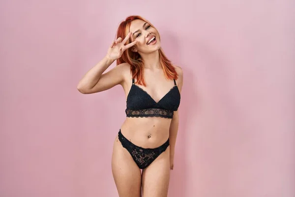 Young Caucasian Woman Wearing Lingerie Pink Background Doing Peace Symbol — 스톡 사진