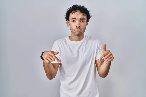 Hispanic Man Standing Isolated Background Pointing Looking Sad Upset Indicating — Stock Photo, Image