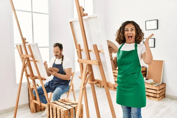 Hispanic Middle Age Woman Mature Man Art Studio Celebrating Victory — Stock Fotó