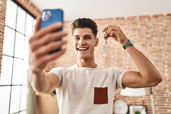 Young Hispanic Man Having Video Call Holding Key House New — Zdjęcie stockowe