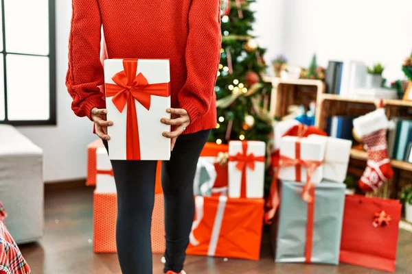 年轻的惊慌失措的女人背着礼物 站在家里的圣诞树旁 — 图库照片