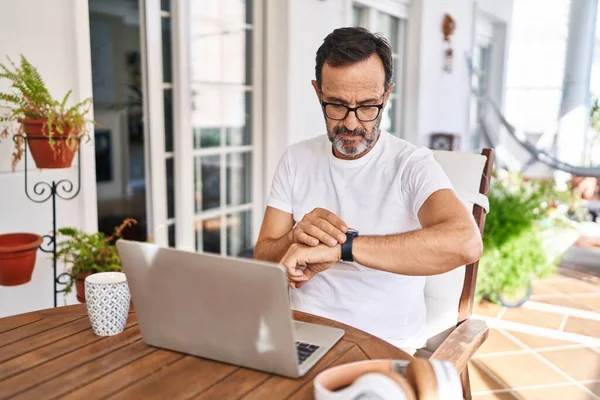 Middle Age Man Using Computer Laptop Home Checking Time Wrist — Stockfoto