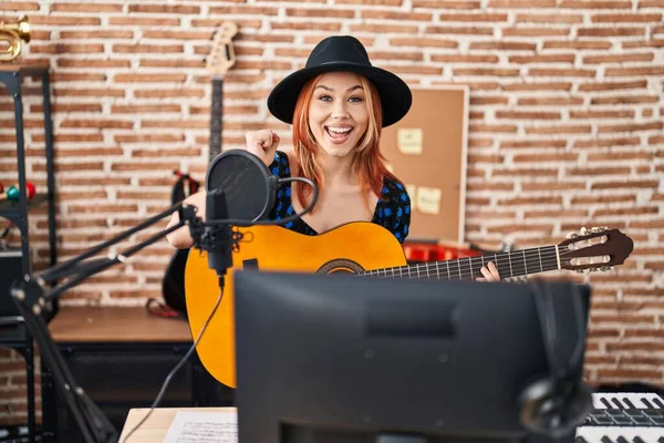 Young Caucasian Woman Playing Classic Guitar Music Studio Screaming Proud — Stock Photo, Image