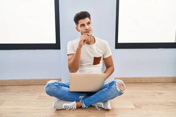 Young Hispanic Man Using Laptop Home Hand Chin Thinking Question — Stockfoto