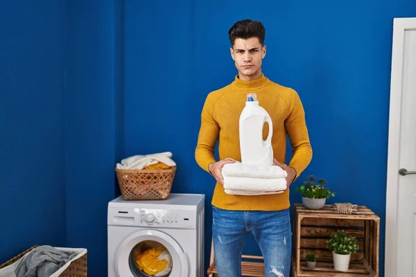 Young Hispanic Man Holding Clean Towels Skeptic Nervous Frowning Upset — Stok fotoğraf