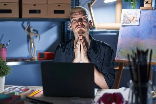 Young Caucasian Man Using Laptop Night Art Studio Begging Praying — Stockfoto