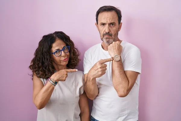 Middle Age Hispanic Couple Together Pink Background Hurry Pointing Watch — Fotografia de Stock