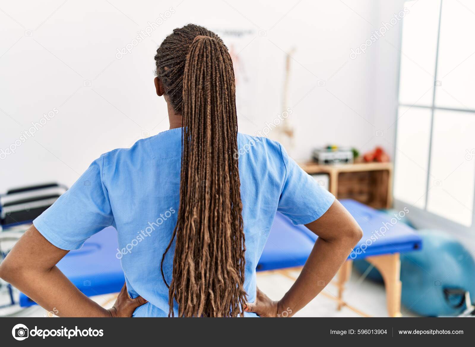 Black Woman Braids Working Pain Recovery Clinic Standing Backwards Looking Stock Photo by