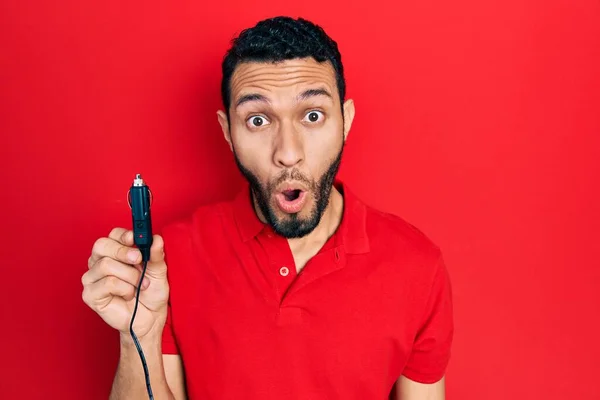 Hispanic Man Beard Holding Car Charger Scared Amazed Open Mouth — Stock fotografie