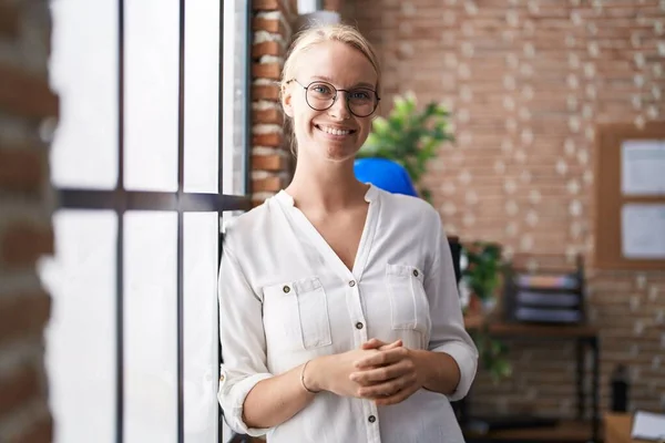 Young blonde woman business worker smiling confident standing at office