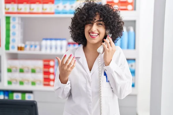 Young Middle East Woman Pharmacist Talking Telephone Pharmacy — Zdjęcie stockowe