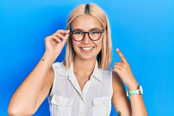 Beautiful Blonde Woman Wearing Glasses Smiling Happy Pointing Hand Finger — Stockfoto