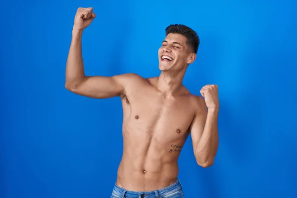 Young Hispanic Man Standing Shirtless Blue Background Dancing Happy Cheerful — Stockfoto