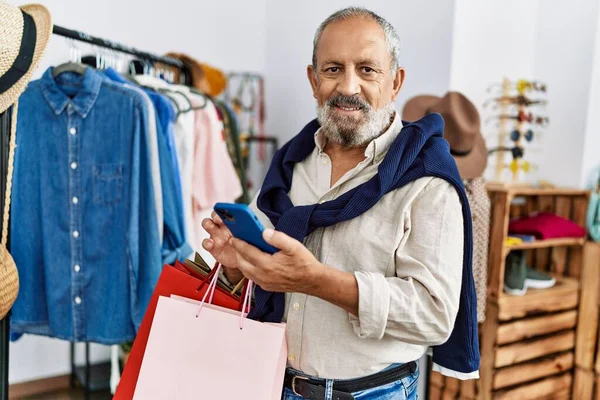 Senior Grey Haired Man Holding Shopping Bags Using Smartphone Clothing — Stock fotografie