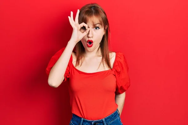 Ruiva Jovem Mulher Vestindo Casual Camiseta Vermelha Fazendo Gesto Chocado — Fotografia de Stock