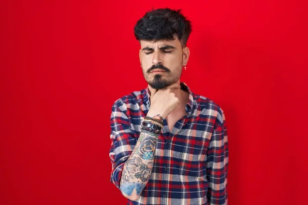 Young Hispanic Man Beard Standing Red Background Touching Painful Neck — Stockfoto