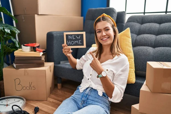 Young Blonde Woman Holding New Home Blackboard Smiling Happy Pointing — Stockfoto