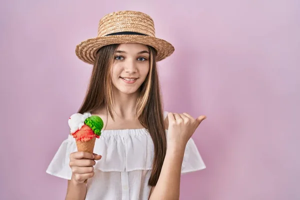 Teenager Girl Holding Ice Cream Pointing Back Hand Thumbs Smiling — Stockfoto