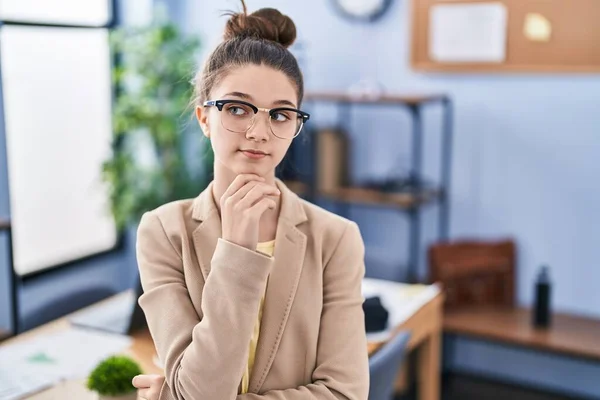 Teenager Girl Working Office Wearing Glasses Serious Face Thinking Question — Stockfoto