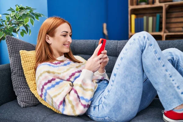 Mujer Joven Caucásica Usando Teléfono Inteligente Tumbado Sofá Casa —  Fotos de Stock