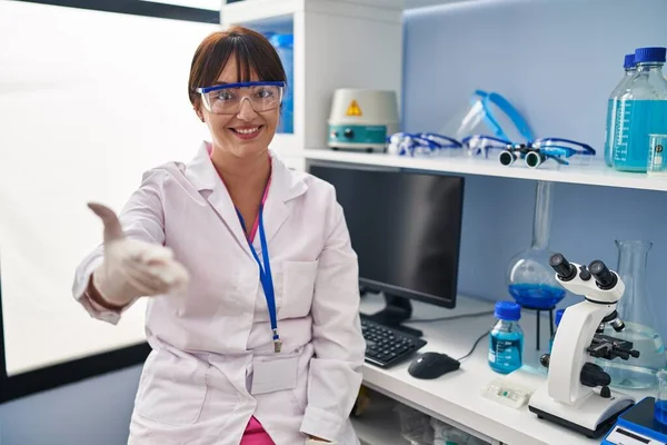 Young Brunette Woman Working Scientist Laboratory Smiling Friendly Offering Handshake — Stock fotografie