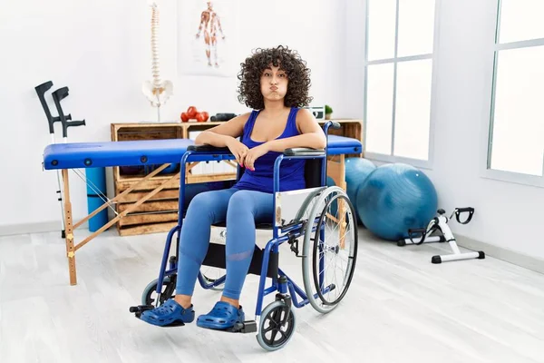 Young Middle Eastern Woman Sitting Wheelchair Physiotherapy Clinic Puffing Cheeks — Stok fotoğraf