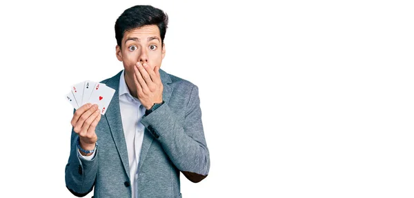 Young Hispanic Business Man Playing Poker Holding Cards Covering Mouth — Stock Photo, Image