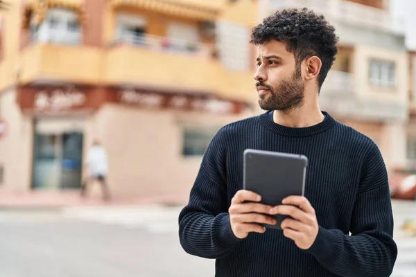 Young Arab Man Relaxed Expression Using Touchpad Street —  Fotos de Stock