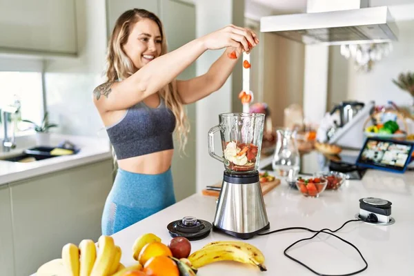 Young Woman Smiling Confident Pouring Strawberries Blender Kitchen — Stok fotoğraf