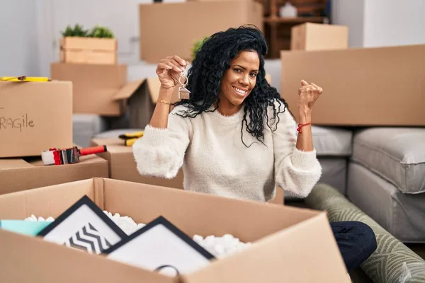 Orta yaşlı İspanyol kadın yeni evinin anahtarlarını tutuyor. Gururla bağırıyor, zaferi kutluyor ve kollarını kaldırdığı için çok heyecanlı. 