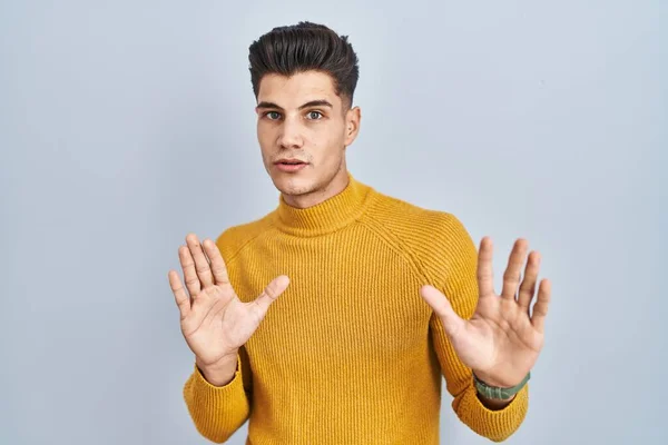 Young Hispanic Man Standing Blue Background Moving Away Hands Palms — Photo