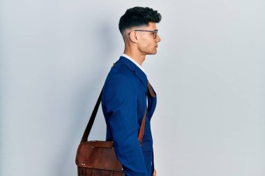 İş kıyafetleri giyen genç İspanyol bir adam profilini rahatlatmak için kendine güvenen bir gülümsemeyle doğal bir poz veriyor.. 