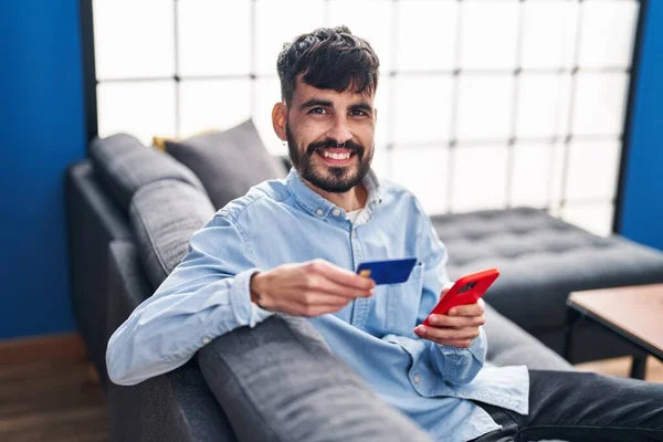 Young Hispanic Man Using Smartphone Credit Card Home — Stock fotografie