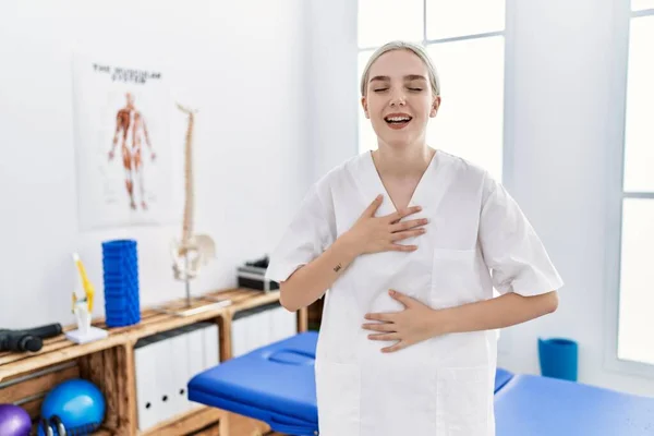 Young Caucasian Woman Working Pain Recovery Clinic Smiling Laughing Hard — Fotografia de Stock