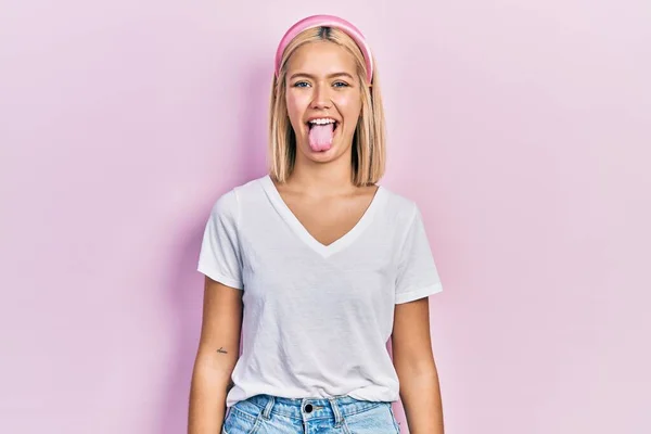 Beautiful Blonde Woman Wearing Casual White Shirt Sticking Tongue Out — Foto de Stock