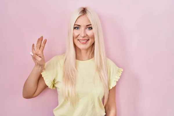 Caucasian Woman Standing Pink Background Showing Pointing Fingers Number Four — 图库照片