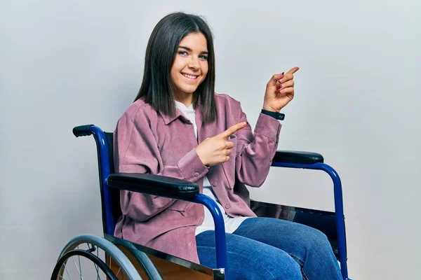 Young Brunette Woman Sitting Wheelchair Smiling Looking Camera Pointing Two — Photo