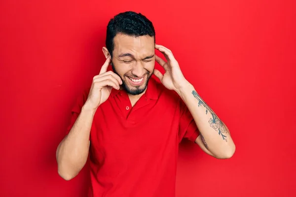 Hispanic Man Beard Wearing Casual Red Shirt Covering Ears Fingers — Stok fotoğraf